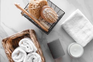 An assortment of bath accessories including towels, sponges, and candles.