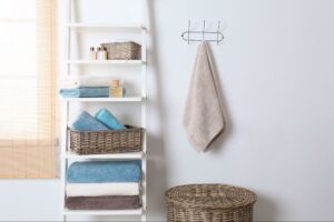 A white ladder serving as a rack stocked with towels.
